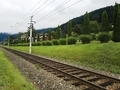 view of the railway passing in the village against the backdrop of the mountains - PhotoDune Item for Sale