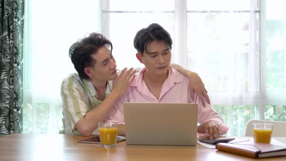 Young man in front of computer feel depressed or stressed while a boyfriend comforting him