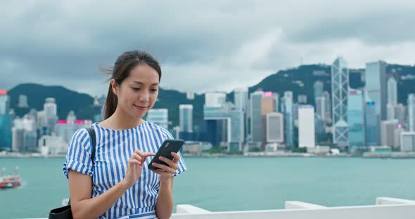 Woman hold with shopping bag and use of mobile phone