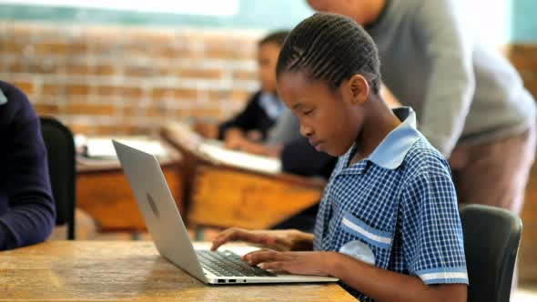 Students using laptop and digital tablet in classroom 4k