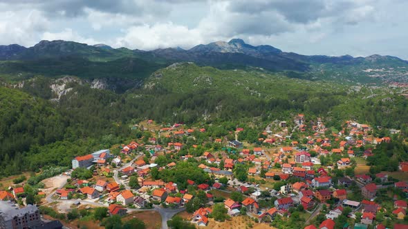 Aerial View of Village Houses with Red Roofs in Cetinje Montenegro Mountains