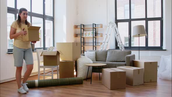 Woman Packing Boxes at and Moving Out House