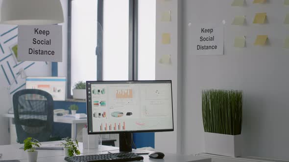 Empty Business Modern Office with Plastic Separators and Keep Social Distance Sign on the Wall