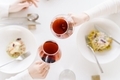 Woman making celebratory toast with red wine. Top view of dinner table - PhotoDune Item for Sale
