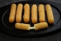 fried mozzarella sticks crispy on a black woden plate isolated on dark gray background
 - PhotoDune Item for Sale