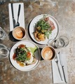 Morning brunch plates with coffee latte and a flat white at a hip and quirky local cafe  - PhotoDune Item for Sale
