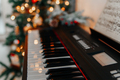 Piano keyboard with bright christmas lights on the background. - PhotoDune Item for Sale