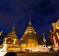 Golden stupa of the Wat Phra Singh at night, Chiang Mai, Thailand - PhotoDune Item for Sale