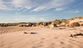Beach rocks and dunes on a beach at sunset in Jacobsbaai, South Africa. - PhotoDune Item for Sale