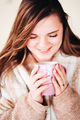 A young woman holds mug of tea - PhotoDune Item for Sale