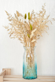 Modern fall and winter home decor Blue glass vase with dry grass on wooden shelf.  - PhotoDune Item for Sale