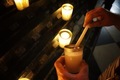 Lighting a candle in a cathedral  - PhotoDune Item for Sale
