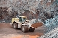 Earthmover in an active quarry mine of porphyry rocks. digging - PhotoDune Item for Sale