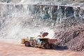 earth mover loading stones on a dumper truck. mining industries. - PhotoDune Item for Sale