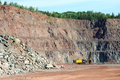 Driller in an open pit mine. porphyry rock material. - PhotoDune Item for Sale