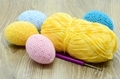 crochet easter eggs in blue pink yellow on wooden background. - PhotoDune Item for Sale