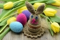 Crochet Easter bunny egg cup and easter eggs made of wool. background bunch of yellow tulips - PhotoDune Item for Sale