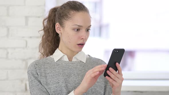 Portrait of Sad Young Latin Woman Getting Loss on Smartphone