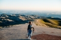 Woman stands and smiles on the road on the top of mountains. Feels free. Freedom.  - PhotoDune Item for Sale