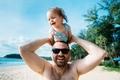Dad and infant daughter having fun together on the beach.  - PhotoDune Item for Sale