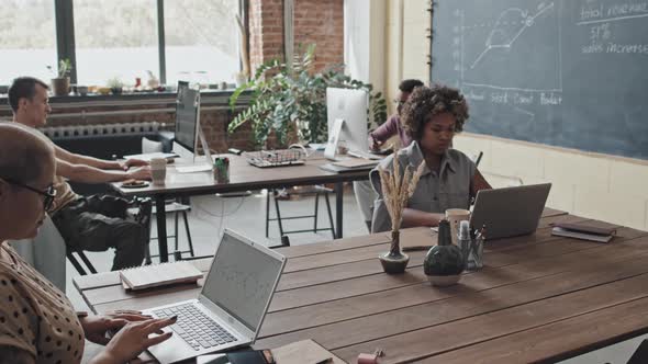 Black Woman Using Computer in Coworking