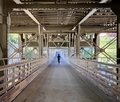 Boy running down the center of a covered bridge... - PhotoDune Item for Sale