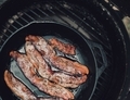 Cooking bacon in a cast iron skillet.  - PhotoDune Item for Sale