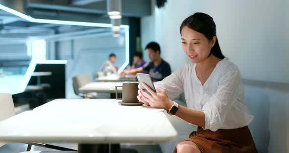 Woman check on cellphone in cafe