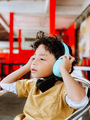boy listen music using turquoise headphone  - PhotoDune Item for Sale