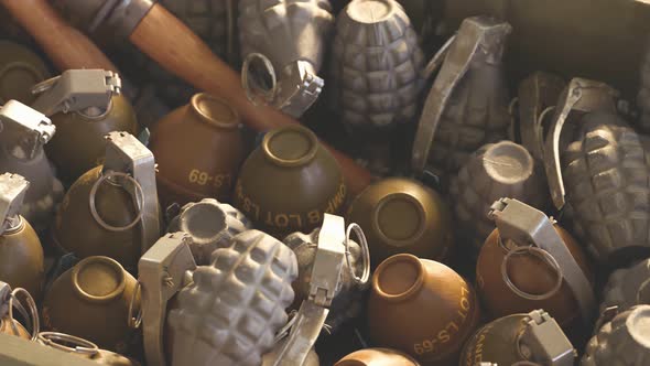 Close up of piled up different types of grenades in wooden ammunition box. 4k HD