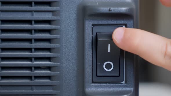 Two Fingers, an Adult and a Child, Press a Black Switch Button