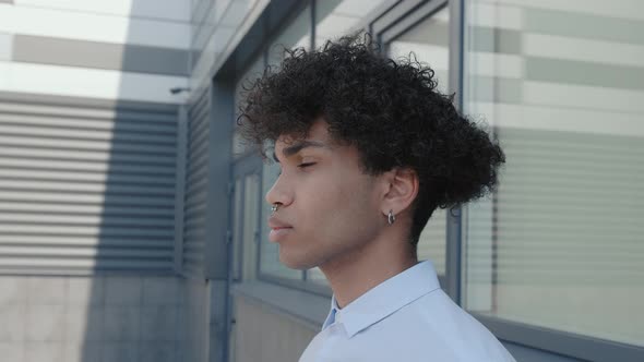 Attractive Mixed Race Male in Headphones and Listening to Music Outdoors