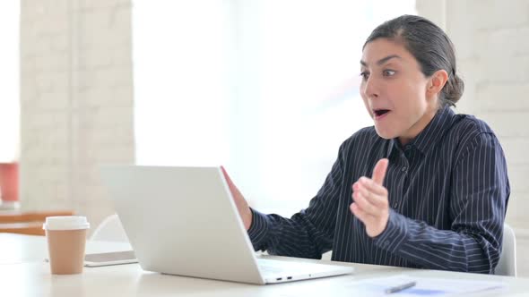 Indian Woman Celebrating Success on Laptop