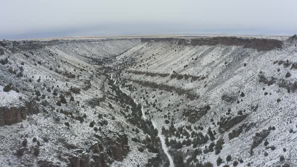 Slow tracking drone shot of snowy canyon