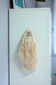 Reusable mesh shopping bag hanging on side of wardrobe - PhotoDune Item for Sale