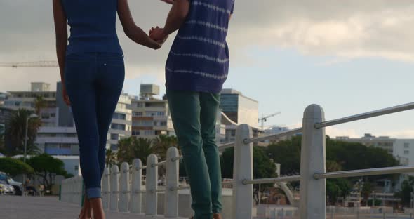 Couple walking hand in hand at beach 4k