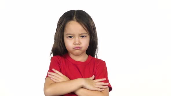 Portrait of Little Girl Crosses Hands Posing at White Background. Slow Motion