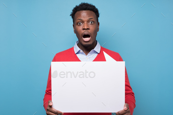 Handsome shocked african business man presenting some product