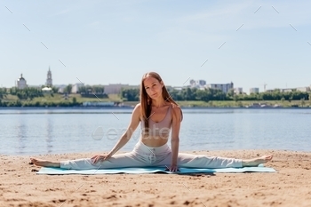 e. Stretching woman outdoor. Seated straddle asana