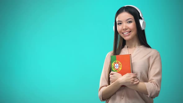 Girl Listening Portuguese Audio Lessons in Headset, Book in Hands, Translations