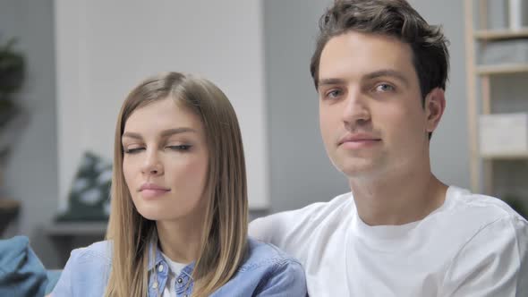 Close Up of Positive Young Couple Looking at Camera