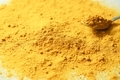 Close up shot of turmeric in a spoon. - PhotoDune Item for Sale