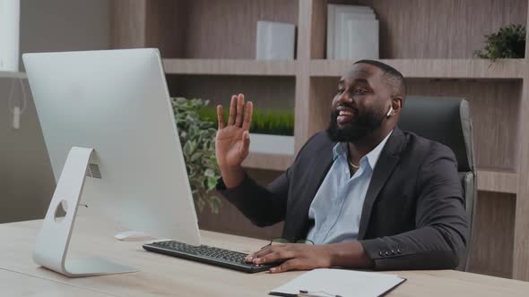 African American Mature Business Man Executive Waving Hand Using Laptop Computer Having Video