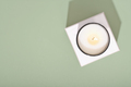 top view of burning candle on green background. natural coconut wax candle, - PhotoDune Item for Sale