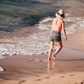 Lady with hat walking in the water at the beach - PhotoDune Item for Sale