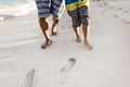 Father And Son Walking On The Sandy Beach At Vacation Time - PhotoDune Item for Sale