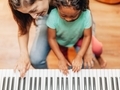 Mother and daughter at the piano dancing to music - PhotoDune Item for Sale
