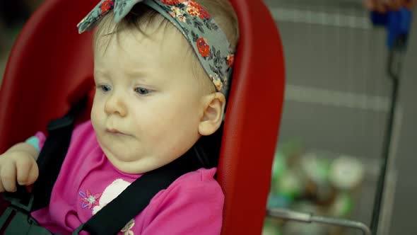 Child Sits in a Specially Equipped Chair 10 in the Supermarket 6