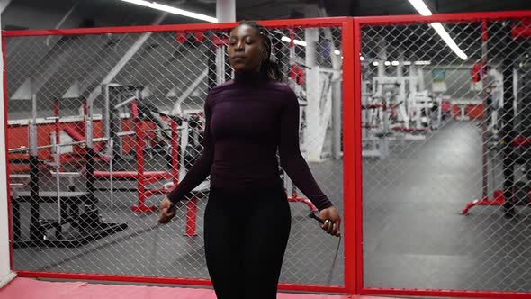 Sports in the Gym  Black Woman Jumping Over the Rope  Endurance Exercise