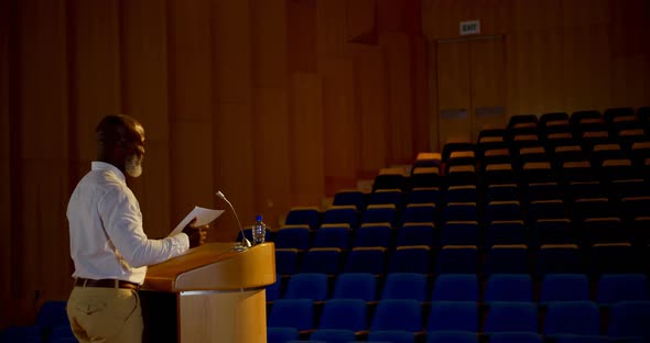 Senior African American businessman practicing speech in empty auditorium 4k